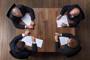 Top view of business people at a meeting table photo