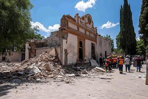 People standing around a building that has been destroyed photo
