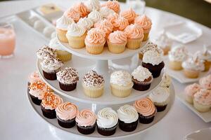 A three tiered cake stand with cupcakes on it photo