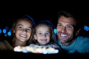 A family is smiling while looking at a cake photo