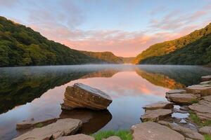 A lake surrounded by rocks and trees at sunrise photo
