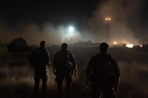 Three soldiers walk through a field at night photo