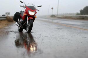 A motorcycle is parked on a wet road photo