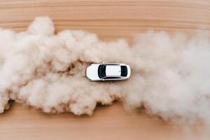A car driving through dust on a desert photo