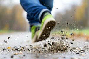 A person running on a road with gravel and dirt photo