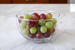 A glass bowl filled with grapes photo