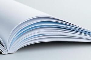 An open book with blue pages on a white background photo