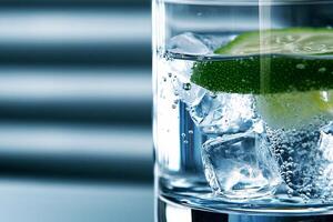 A glass of water with ice and a lime photo