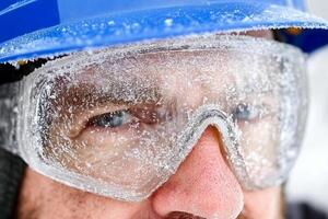 A man wearing a blue helmet and goggles photo