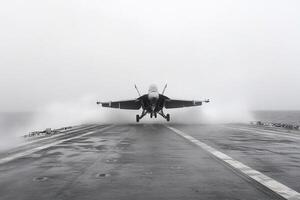 A fighter jet taking off from the deck of an aircraft carrier photo