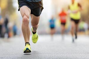 A man running in a marathon with his legs spread out photo