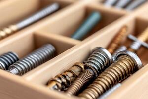 A wooden box with many different types of screws photo