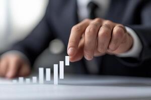 A man in a suit is pointing at a graph bar chart photo