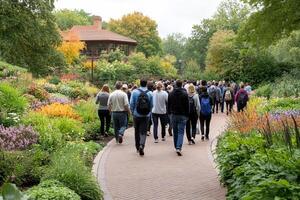 A group of people walking down a path in a garden photo