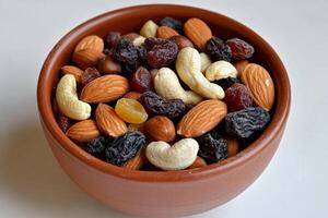 A bowl of mixed nuts and dried fruits photo