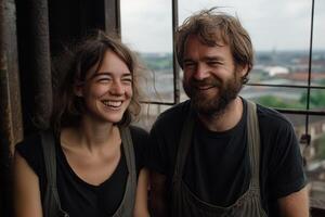 A man and woman smiling in front of a window photo