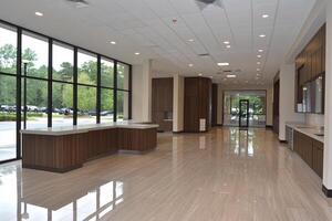 A large lobby with large windows and wood floors photo