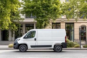 The new fiat van is parked in front of a building photo