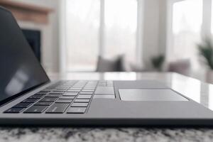 A laptop is sitting on a table in front of a fireplace photo