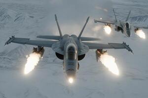 Two fighter jets flying over a snowy mountain range photo