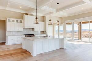 A large white kitchen with a large island photo