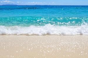 A sandy beach with waves and a blue ocean photo