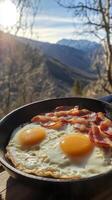 Scrumptious Fried Eggs and Bacon with Mountain Views photo