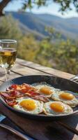 Scrumptious Outdoor Breakfast of Eggs and Bacon with a Scenic Mountain View photo