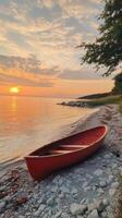 Sunset Serenity Red Boat on a Pebble Beach photo