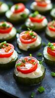 Cucumber Bites Fresh Tomato and Cream Cheese Appetizers on a Dark Plate photo