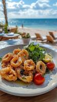 Exquisite Fried Squid Dish with Arugula, Lemon, and Tomatoes on a Beachfront Table, Offering a Taste of Coastal Culinary Delights and Seaside Relaxation photo