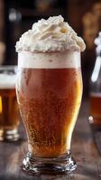 Indulge in a Frothy Delight A Pint of Creamy Beer with Whipped Topping, Refreshing Beverage for Pubs and Bars, Cold Alcohol Drink photo