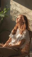 A Womans Peaceful Moment in Radiant Sunlight, Embracing Calm and Relaxation in a Cozy Indoor Setting for Ultimate Wellness photo