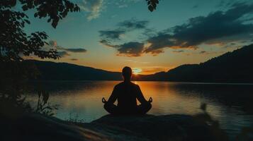 Silhouette of Serenity A Meditative Moment at Sunset on the Lake Find Peace, Balance, and Harmony in Nature's Embrace photo