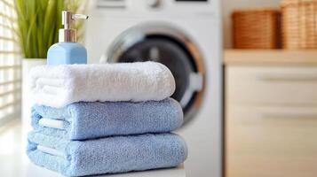 Freshly Laundered Towels Stacked Neatly with Soap Dispenser in a Bright Laundry Room Setting for a Clean and Comfortable Lifestyle photo