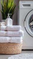 Serene Laundry Day Fresh White Towels Stacked in a Woven Basket Next to a Modern Washing Machine, Promoting Cleanliness and Comfort in a Home Spa Setting photo