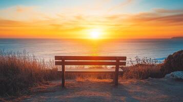 Coastal Sunset Serenity A Bench Overlooking the Tranquil Ocean at Dusk, Offering a Moment of Peace and Contemplation Amidst Nature's Golden Beauty photo