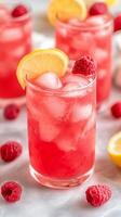 Iced Raspberry Lemonade A Refreshing Summer Drink with Fresh Raspberries, Lemon Slices, and Ice Cubes for a Sweet and Tangy Flavor Explosion photo