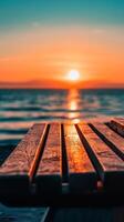 Serene Sunset Seascape Wooden Bench Overlooking the Tranquil Ocean at Dusk, a Beautiful and Relaxing Natural Scene with Warm Light and Reflections photo
