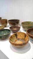 Artisanal Ceramic Bowls A Collection of Handmade Pottery for Rustic Kitchenware and Decorative Tableware, Displayed in a Minimalist Studio Setting photo