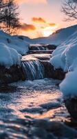 Enthralling Winter Landscape A Cascade of Water Flowing Through Snowy Rocks at Sunset, Embraced by the Serenity of Nature's Icy Embrace photo