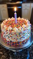 Colorful Birthday Cake with Candle and Sprinkles for a Joyful Celebration photo