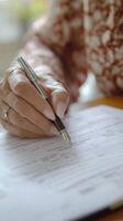 Elderly Person Filling Out Important Documents photo