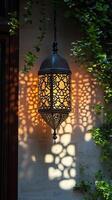 Intricate Lantern Casts Elegant Shadows on Stone Wall photo