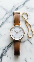 Sleek Gold-Tone Watch with Brown Leather Strap photo