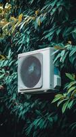 Modern Cooling Unit Amidst Lush Greenery photo