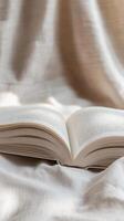 Open Book on Beige Linen Fabric - A Peaceful Reading Moment photo