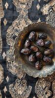 Dark Dates in Antique Bowl on Luxurious Textile photo