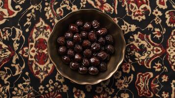Dark Brown Dates in a Bowl on a Patterned Table photo