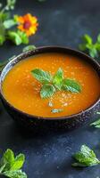 Vibrant Orange Soup with Fresh Mint photo